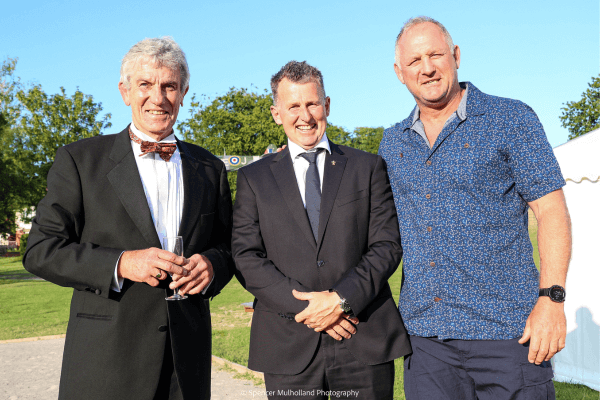 Image shows a man standing in black tie with Professional Referee Nigel Owens, and 2003 World Cup Winner, Richard Hill.